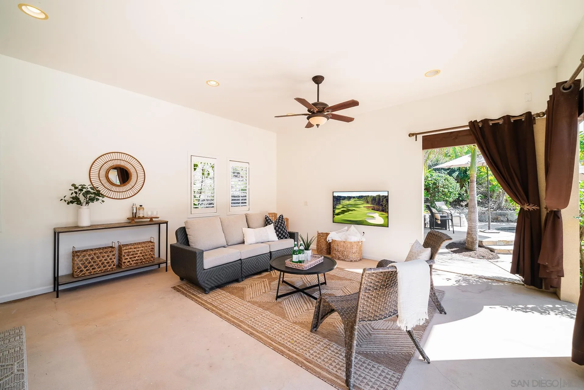 14757 Whispering Ridge Road San Diego, CA 92131 - Photo 30 of 48 a living room with furniture a window and a flat screen tv