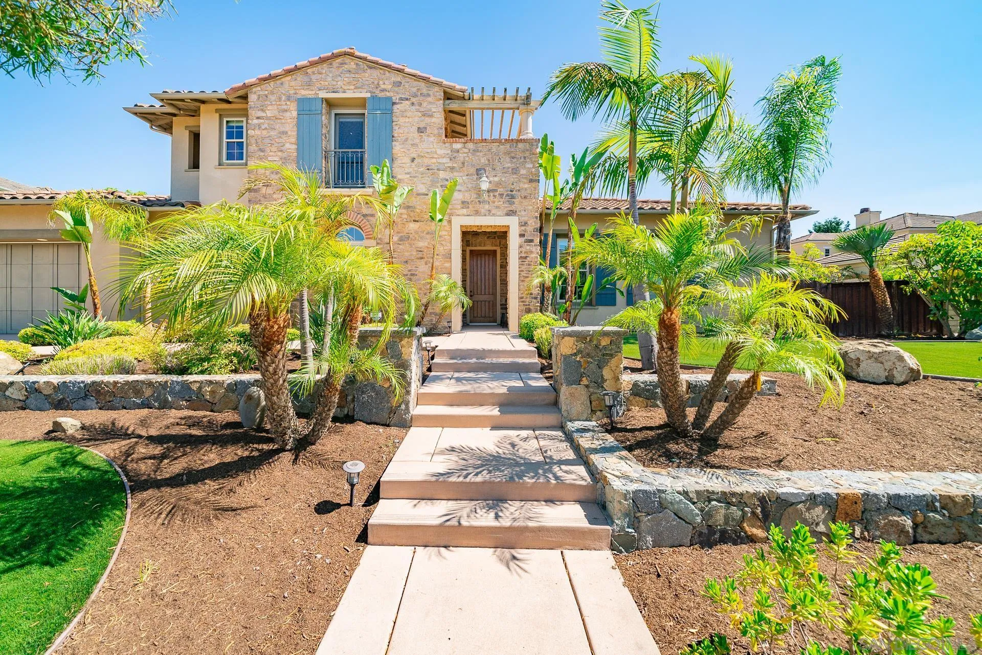 14757 Whispering Ridge Road San Diego, CA 92131 - Photo 5 of 48 a front view of a house with a garden