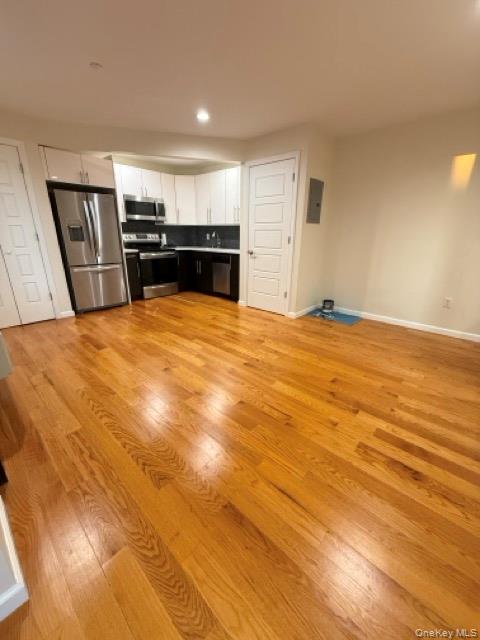31-10 28th Road, Unit 3D Queens, NY 11102 - Photo 8 of 11 a view of empty room with wooden floor
