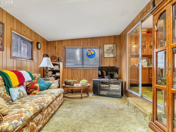 a living room with furniture and large window