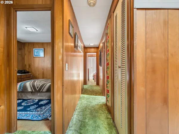 a view of a hallway to a livingroom with furniture