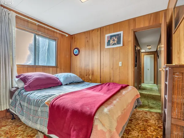 a bedroom with a bed and a mirror