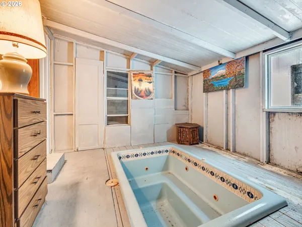 a bathroom with a bathtub and shower