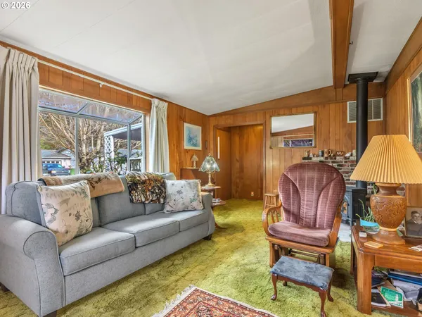 a living room with furniture rug and a window