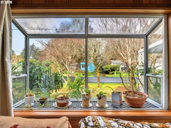 a view of a living room filled with furniture and a window