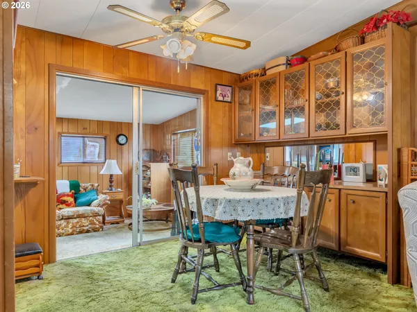 a view of a dining room with furniture wooden floor and a chandelier