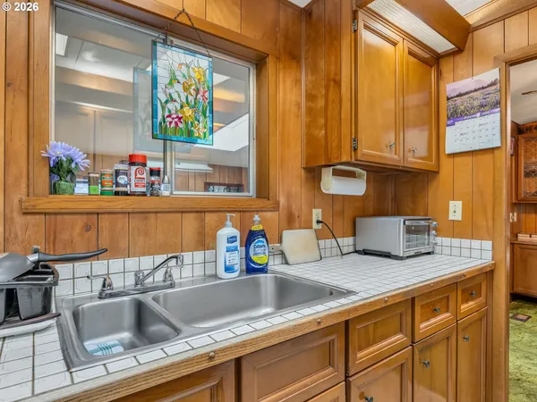 a kitchen with stainless steel appliances granite countertop a sink and a window