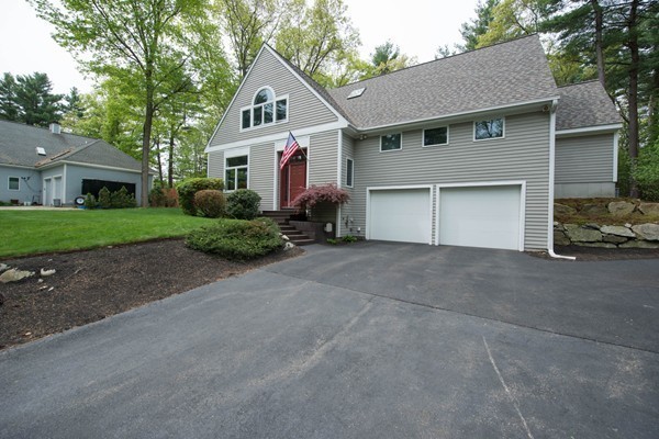 8 Frost Street Natick, MA 01760 - Photo 15 of 28 a front view of a house with a yard and garage