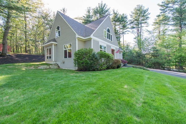 8 Frost Street Natick, MA 01760 - Photo 17 of 28 a front view of a house with a garden and yard