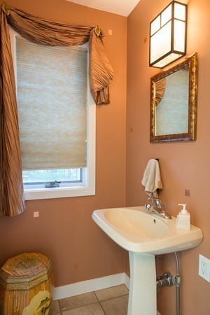 8 Frost Street Natick, MA 01760 - Photo 18 of 28 a bathroom with a sink a mirror and a toilet