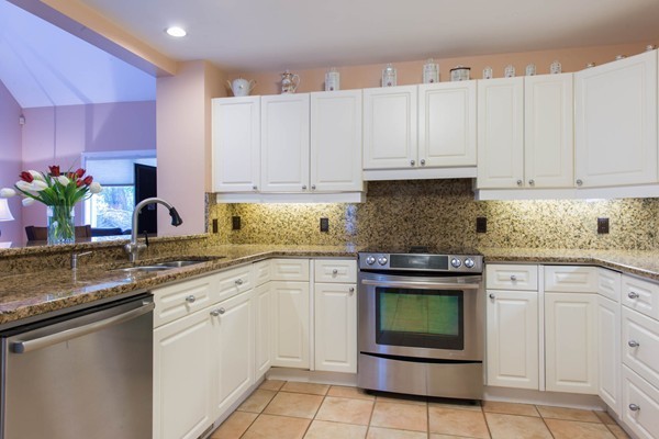 8 Frost Street Natick, MA 01760 - Photo 3 of 28 a kitchen with granite countertop a sink stainless steel appliances and cabinets