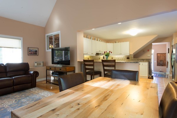 8 Frost Street Natick, MA 01760 - Photo 6 of 28 a living room with stainless steel appliances kitchen island granite countertop furniture and a flat screen tv