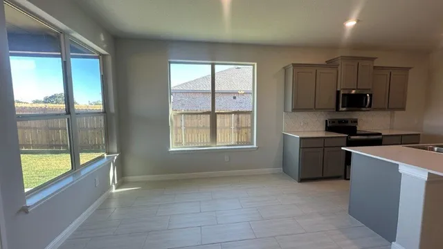 a kitchen with a sink appliances and cabinets