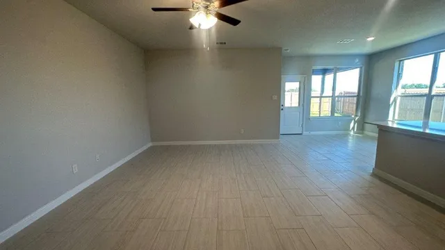 a kitchen with a window a sink and a microwave
