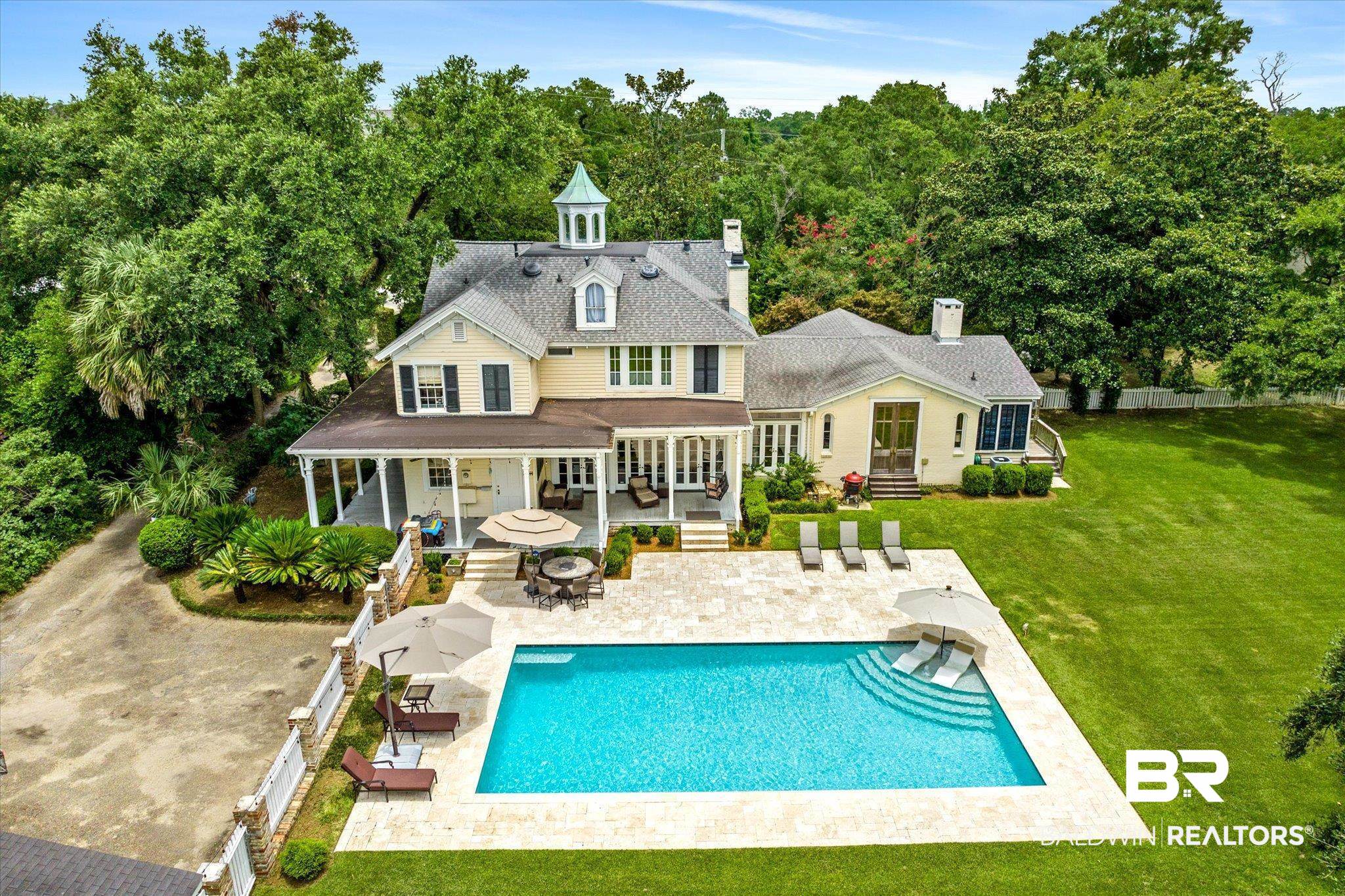 2205 Spring Hill Avenue Mobile, AL 36607 - Photo 52 of 59 Rear view of house with an outdoor fire pit, a patio, a fenced in pool, and a lawn