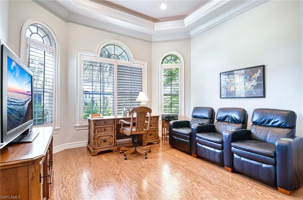 3002 Crayton Road Naples, FL 34103 - Photo 12 of 27 a living room with furniture and a flat screen tv