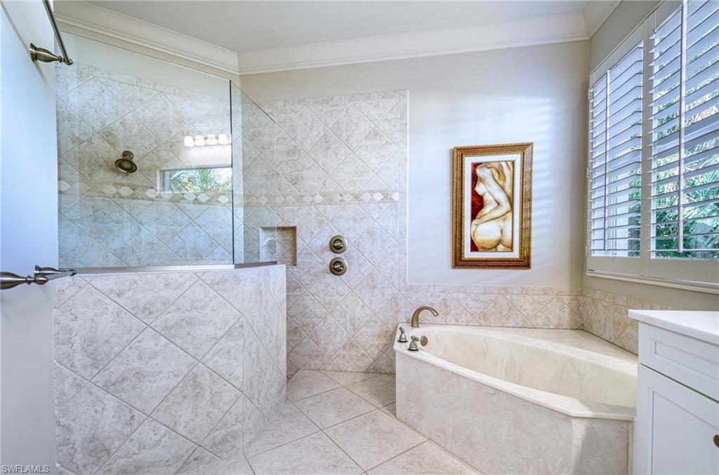 3002 Crayton Road Naples, FL 34103 - Photo 19 of 27 a bathroom with a bathtub and a shower