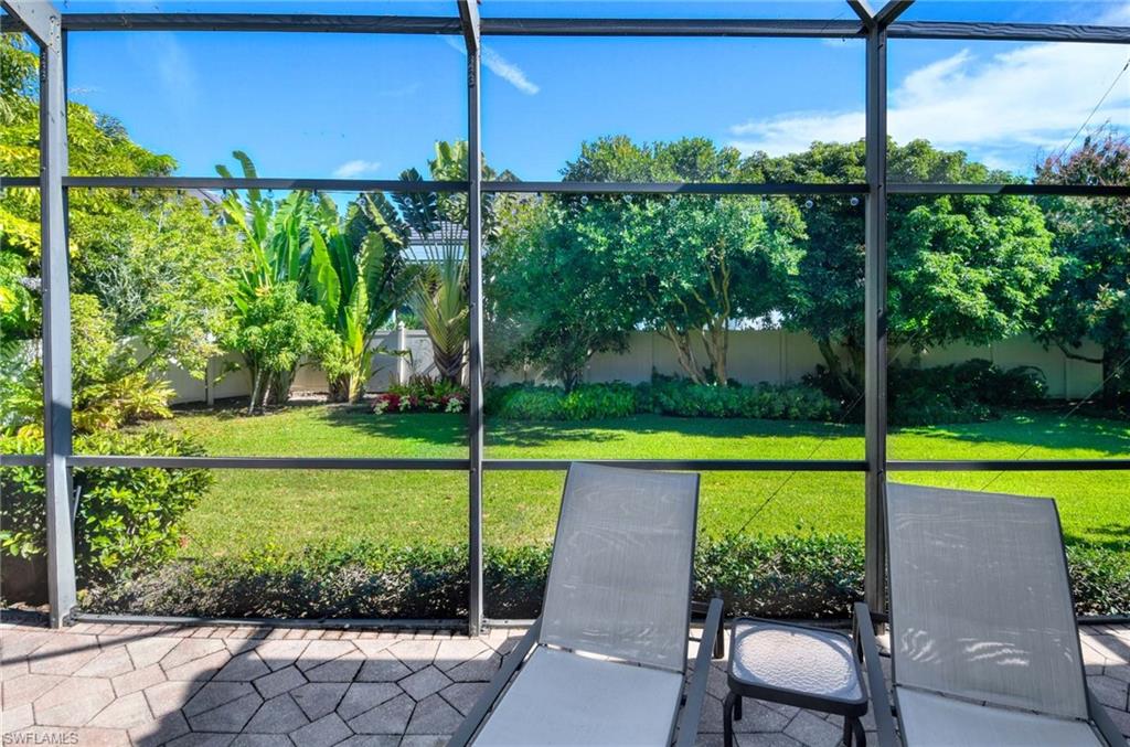 3002 Crayton Road Naples, FL 34103 - Photo 22 of 27 a view of a backyard with a garden and plants