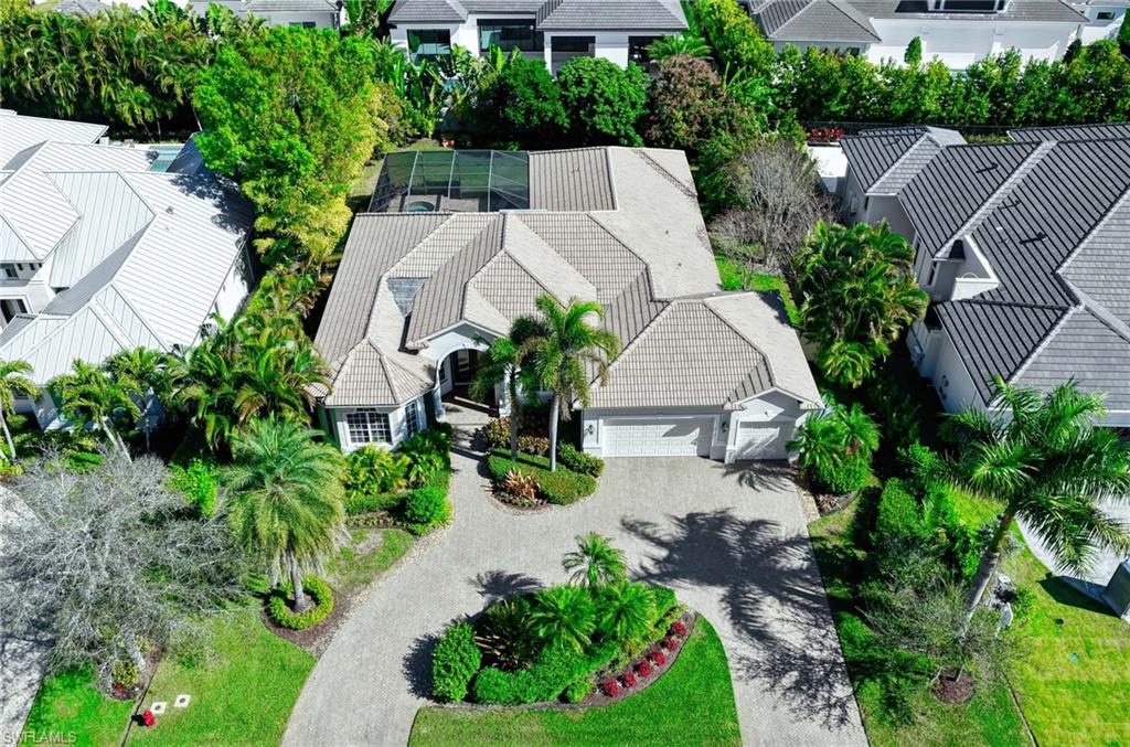 3002 Crayton Road Naples, FL 34103 - Photo 25 of 27 an aerial view of a house with yard and lake view