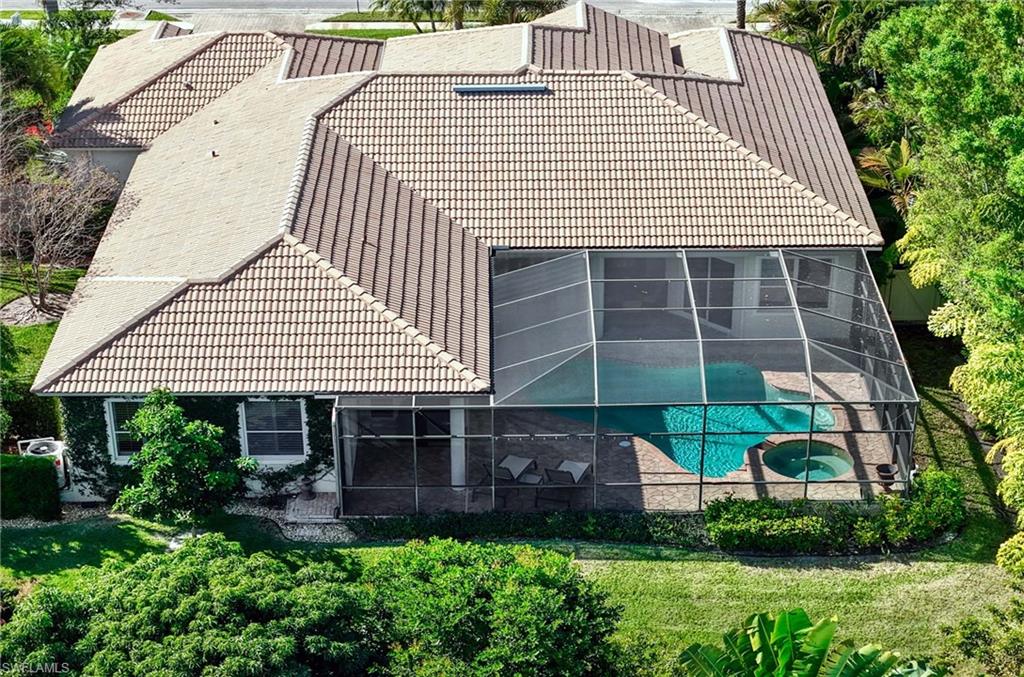 3002 Crayton Road Naples, FL 34103 - Photo 26 of 27 a front view of a house with a garden