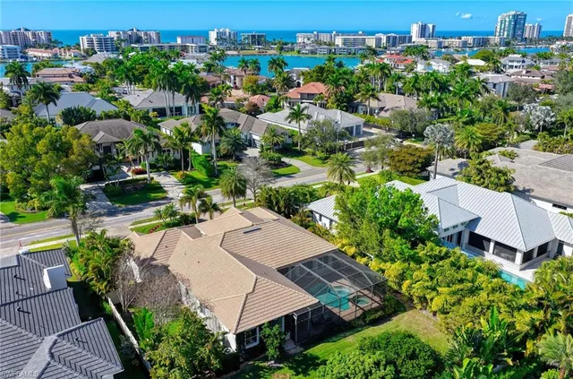 an aerial view of multiple houses with yard