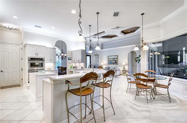 a large kitchen with a table and chairs