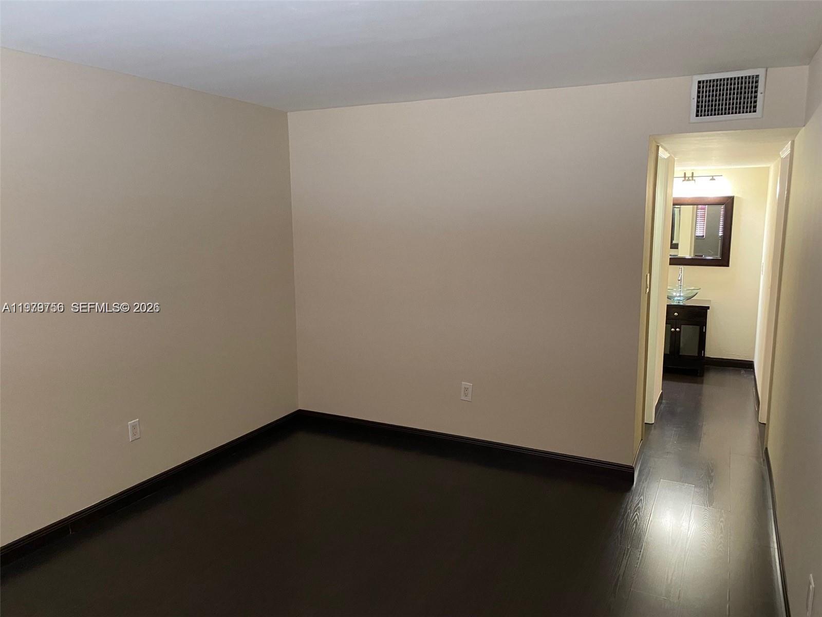 8002 Southwest 149th Avenue, Unit B409 Miami, FL 33193 - Photo 12 of 15 an empty room with a bench