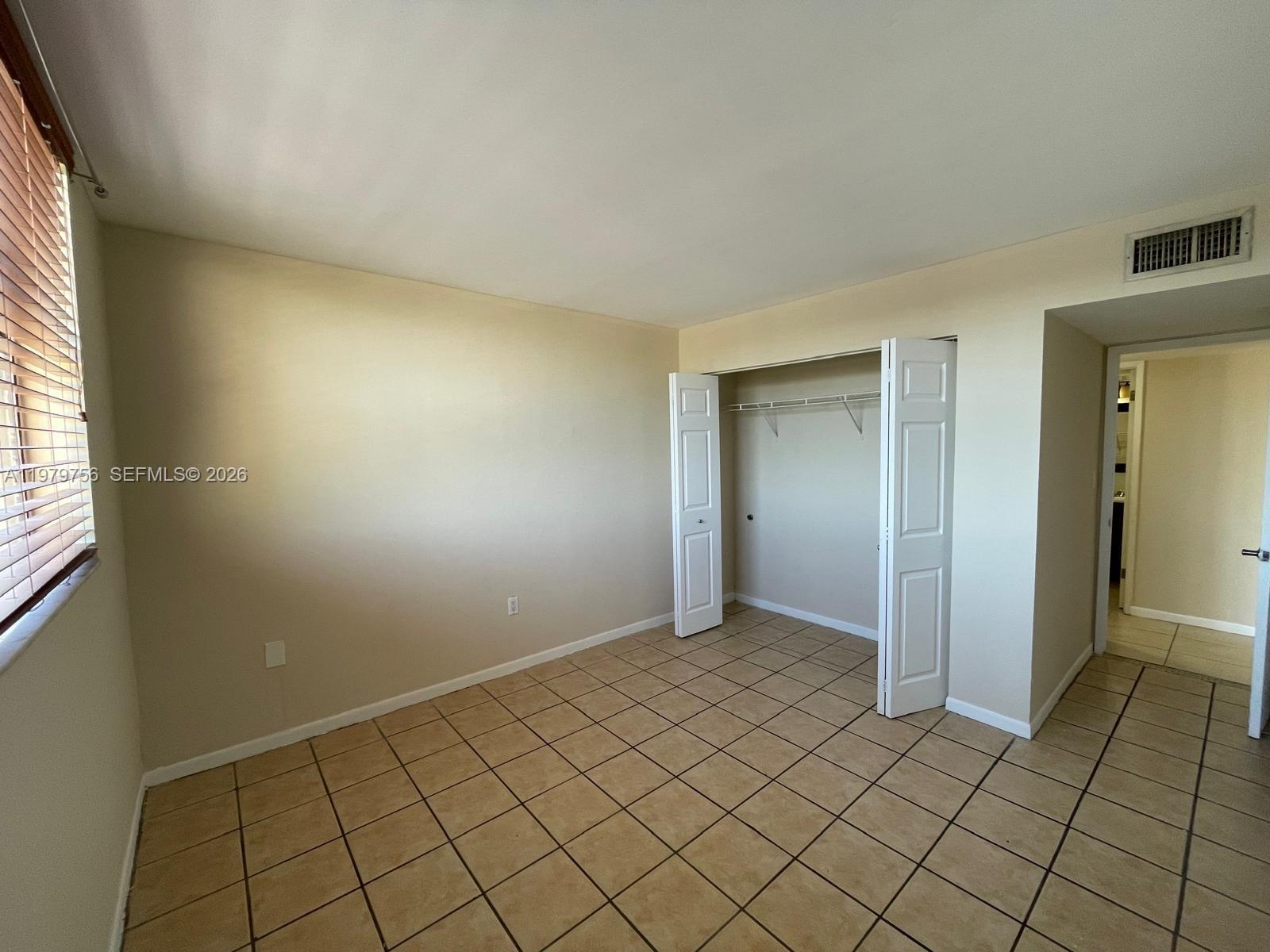8002 Southwest 149th Avenue, Unit B409 Miami, FL 33193 - Photo 13 of 23 a view of an empty room and window