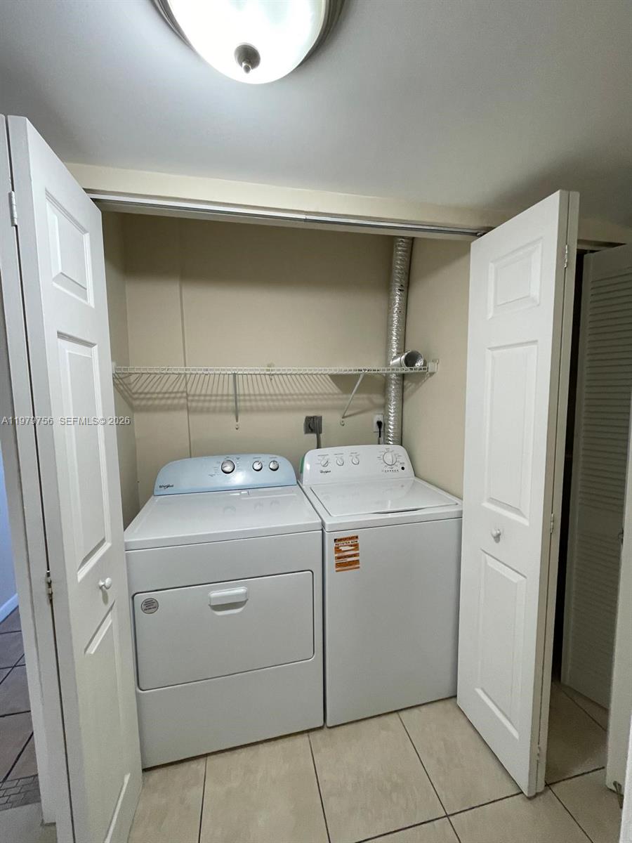 8002 Southwest 149th Avenue, Unit B409 Miami, FL 33193 - Photo 15 of 23 a utility room with dryer and washer