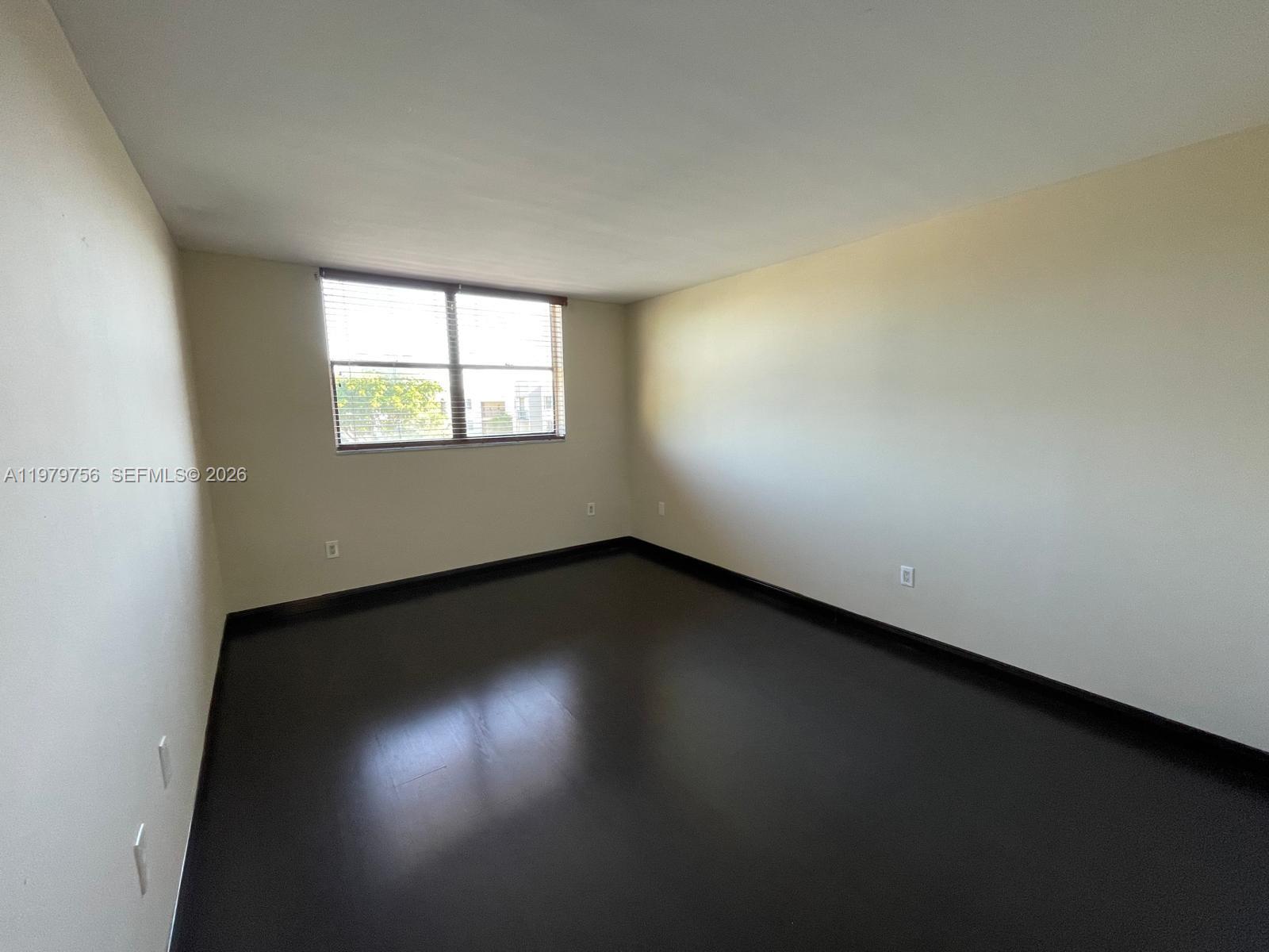8002 Southwest 149th Avenue, Unit B409 Miami, FL 33193 - Photo 17 of 23 an empty room with a window
