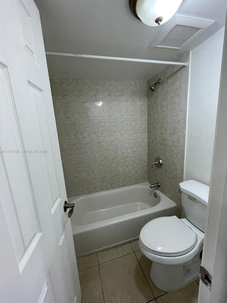8002 Southwest 149th Avenue, Unit B409 Miami, FL 33193 - Photo 22 of 23 a bathroom with a toilet and a bath tub