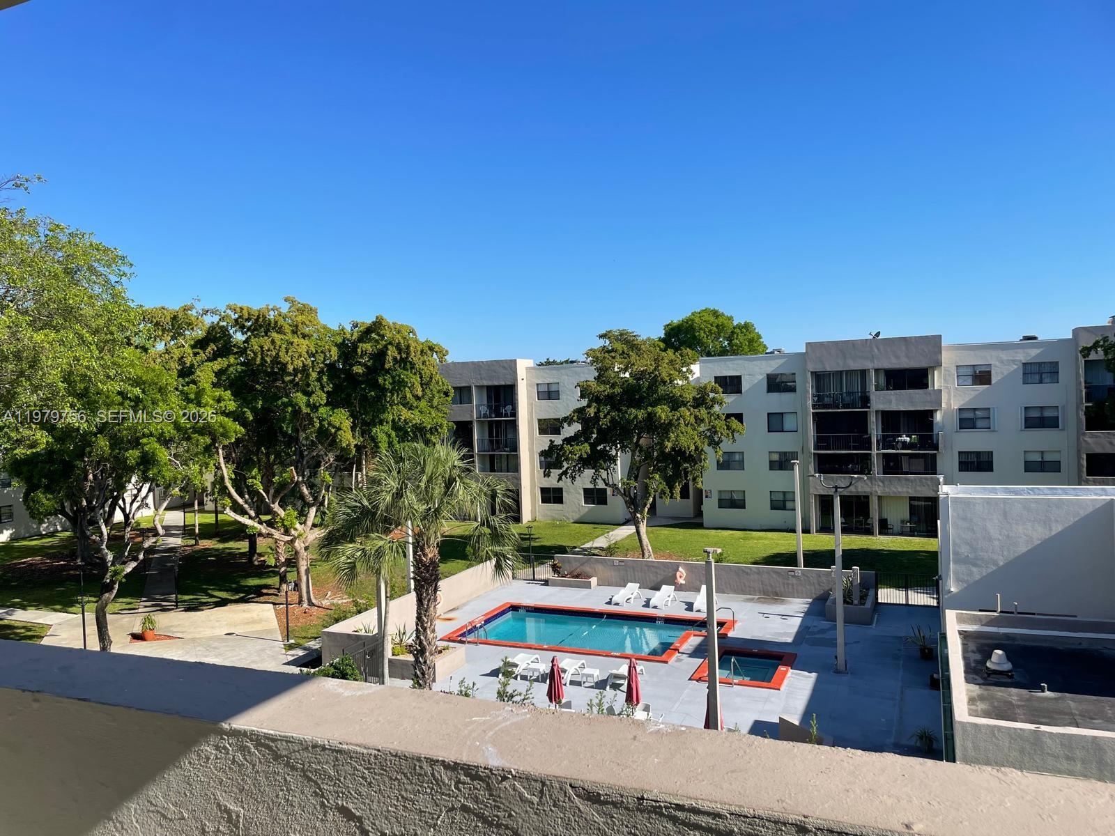 8002 Southwest 149th Avenue, Unit B409 Miami, FL 33193 - Photo 23 of 23 a view of a swimming pool with a patio