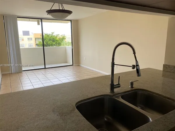 a kitchen with a sink and a large window
