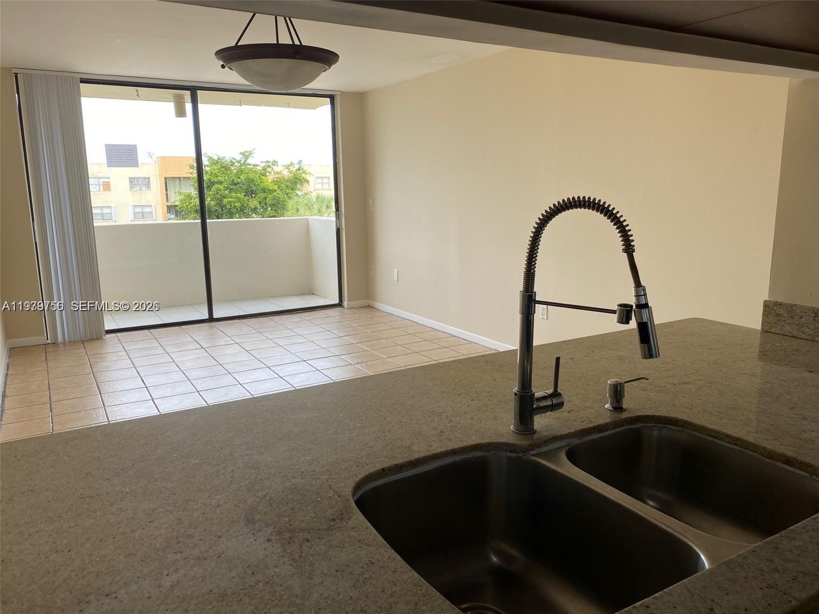 8002 Southwest 149th Avenue, Unit B409 Miami, FL 33193 - Photo 3 of 15 a kitchen with a sink and a large window