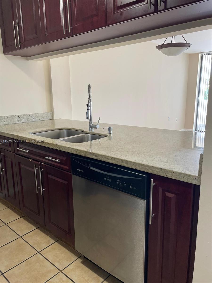 8002 Southwest 149th Avenue, Unit B409 Miami, FL 33193 - Photo 5 of 23 a kitchen with a sink and cabinets