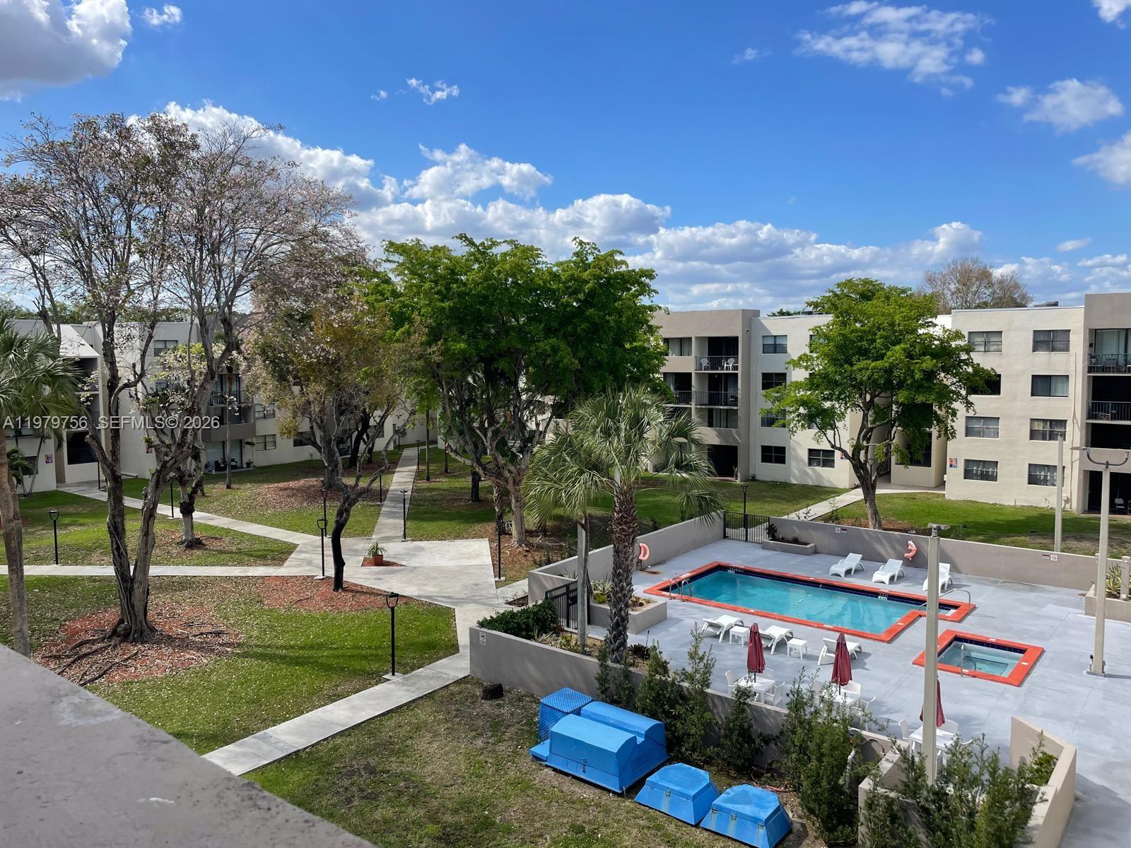 8002 Southwest 149th Avenue, Unit B409 Miami, FL 33193 - Photo 8 of 23 a view of a backyard with plants and patio