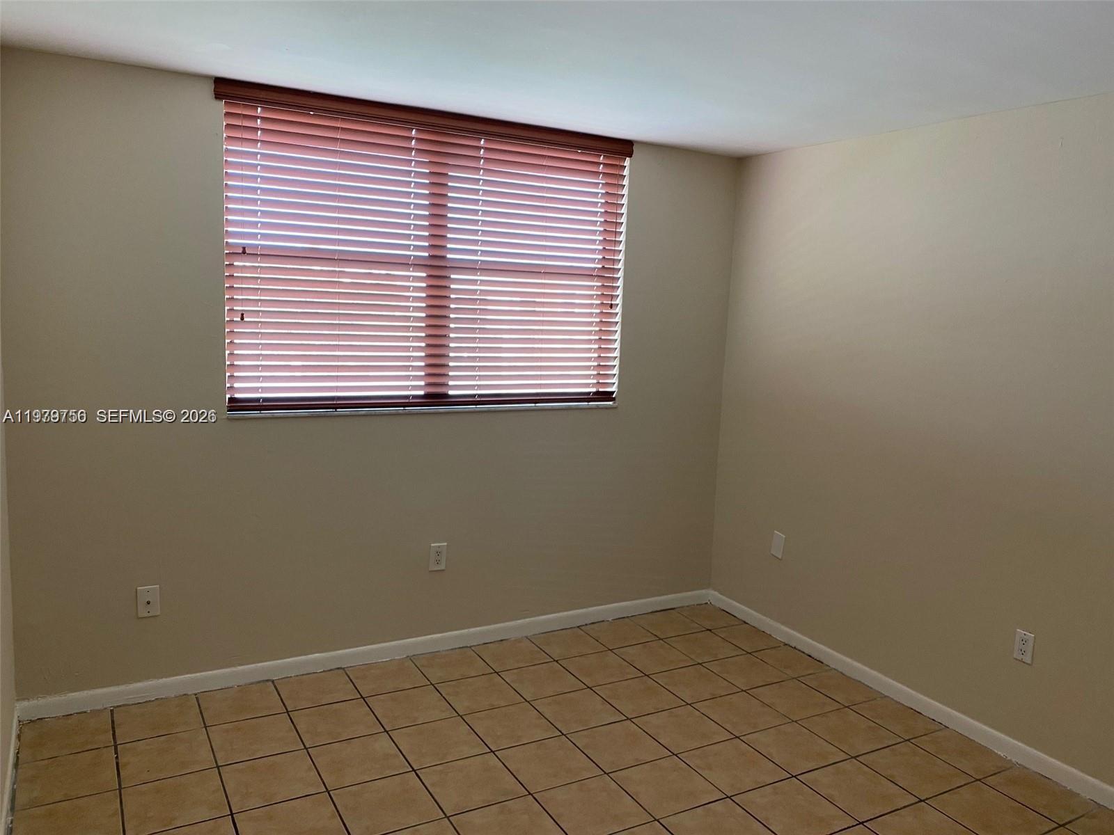 8002 Southwest 149th Avenue, Unit B409 Miami, FL 33193 - Photo 9 of 15 an empty room with a window
