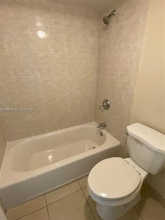 a bathroom with a toilet a sink and bathtub