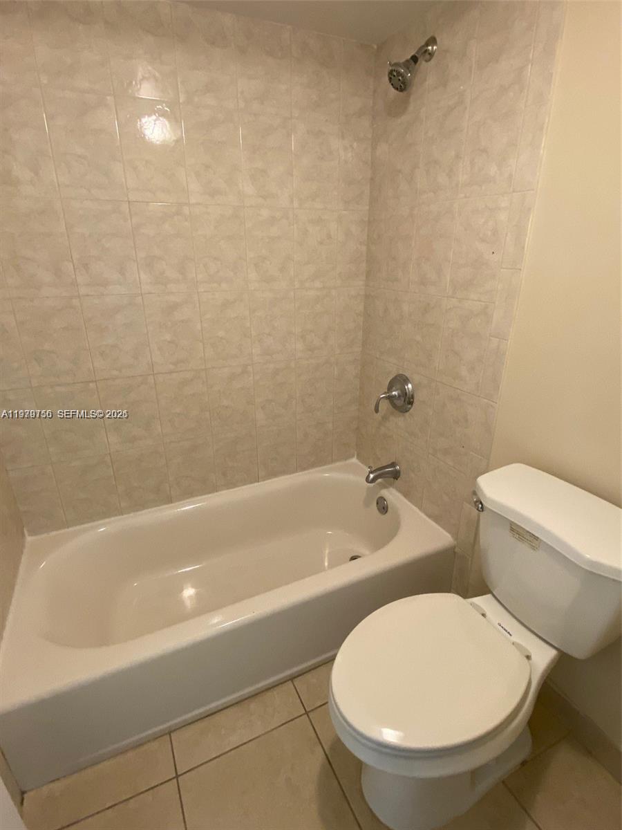 8002 Southwest 149th Avenue, Unit B409 Miami, FL 33193 - Photo 10 of 15 a bathroom with a toilet a sink and bathtub
