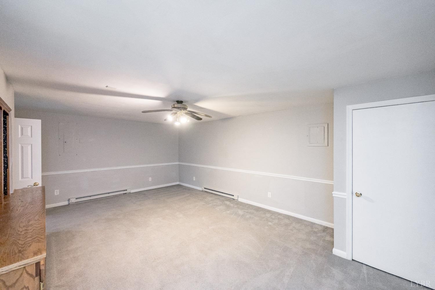 4925 Old Boonsboro Road Lynchburg, VA 24503 - Photo 32 of 57 a view of an empty room with a ceiling fan