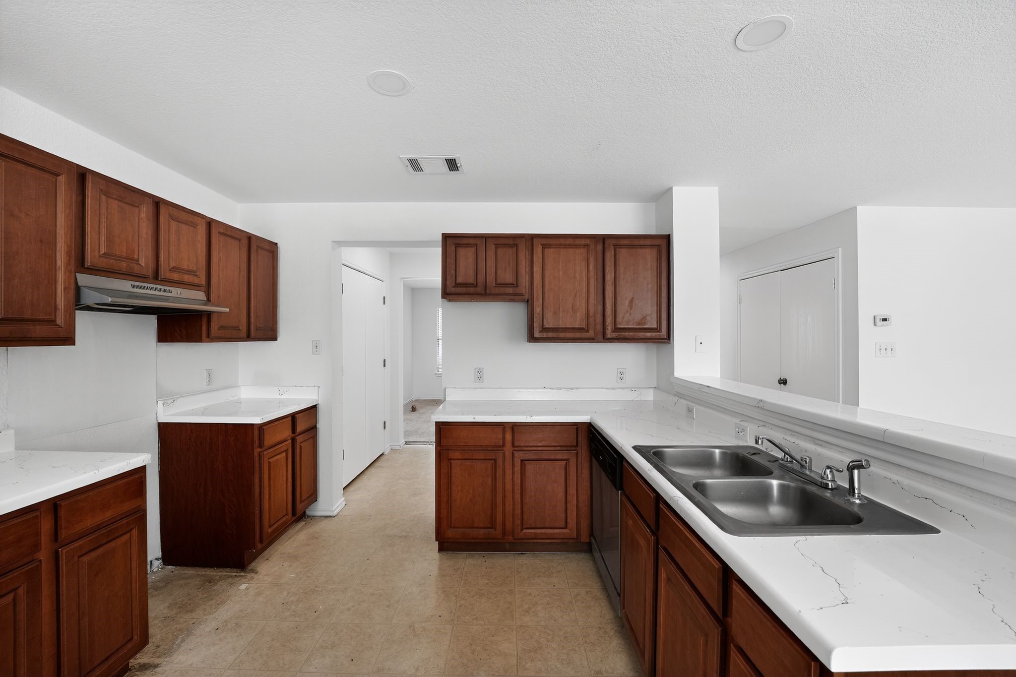 13505 Sierra Wind Lane Elgin, TX 78621 - Photo 12 of 18 a kitchen with stainless steel appliances sink a stove and cabinets