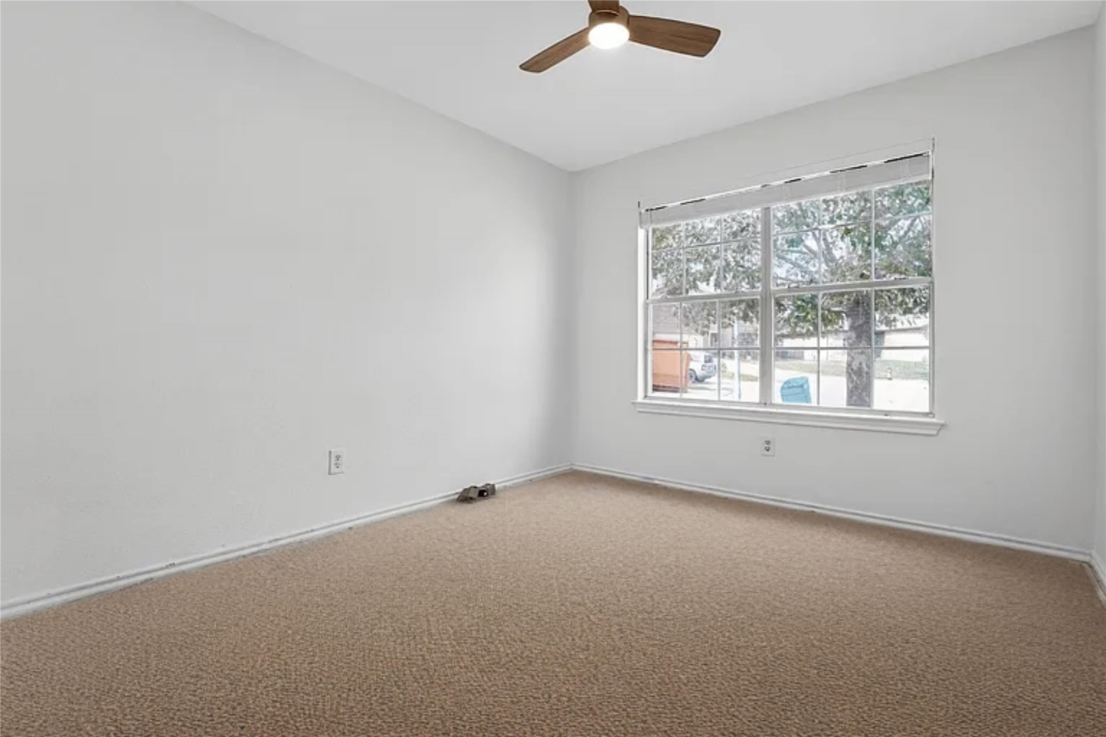 13505 Sierra Wind Lane Elgin, TX 78621 - Photo 8 of 18 an empty room with a window and a ceiling fan