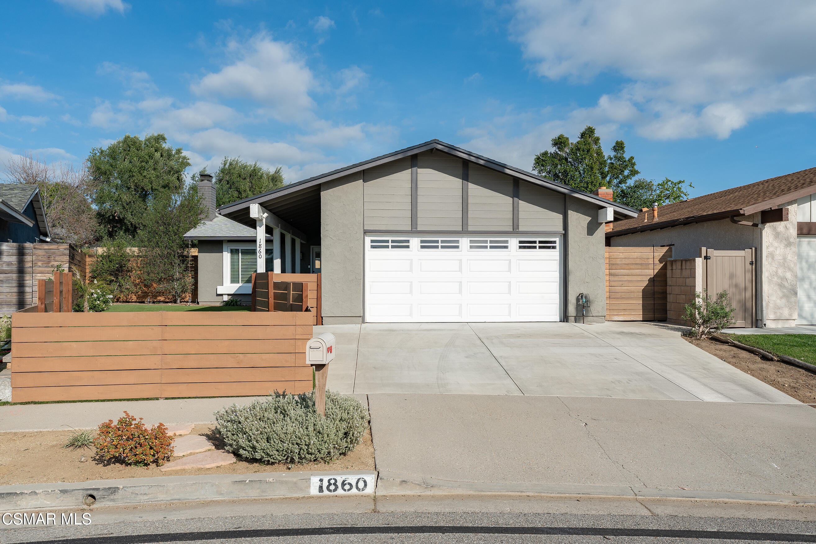 a front view of a house with garage