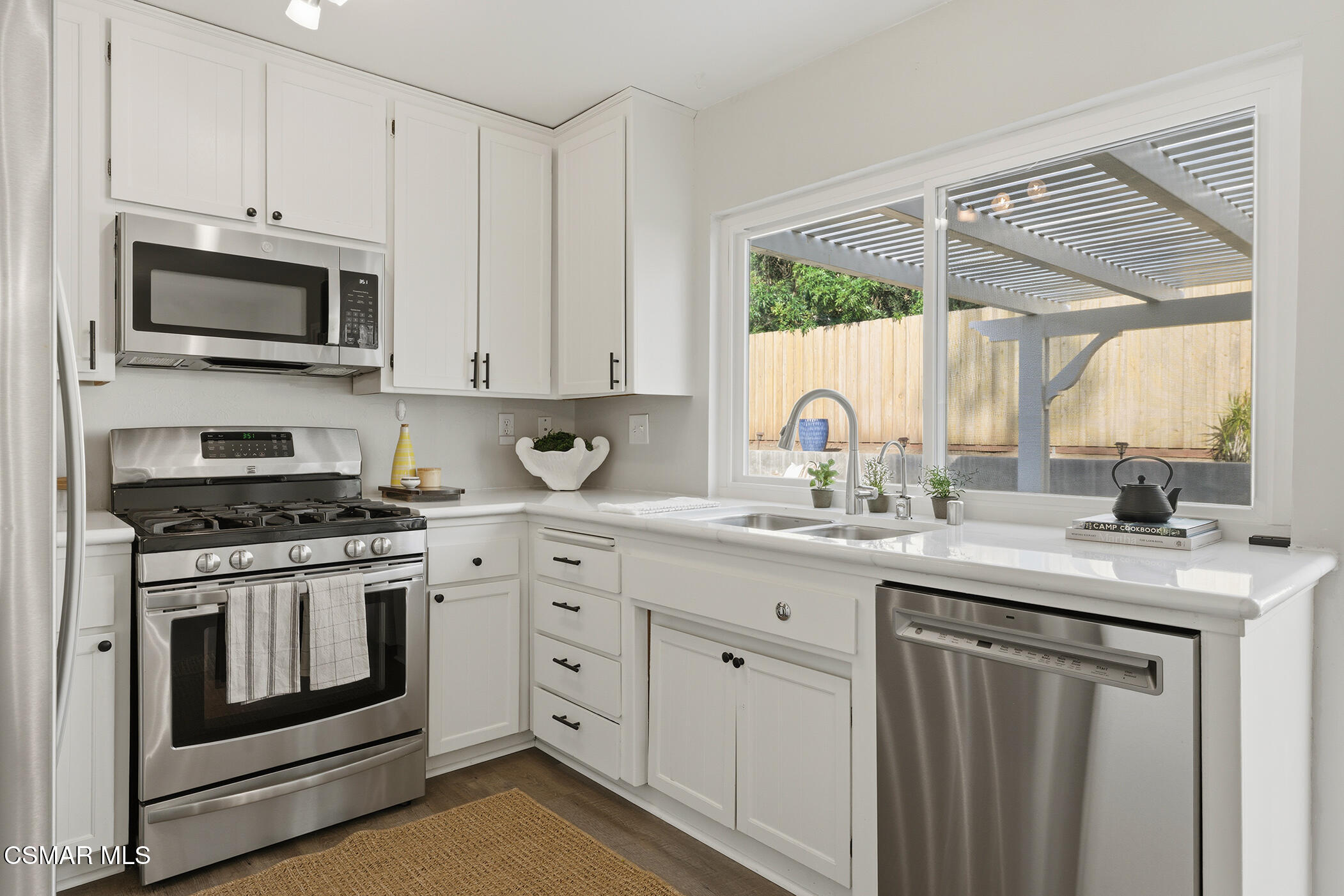 1860 Wychoff Avenue Simi Valley, CA 93063 - Photo 16 of 47 a kitchen with white cabinets and appliances