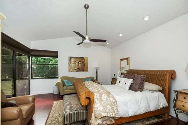 a bedroom with a bed and glass window