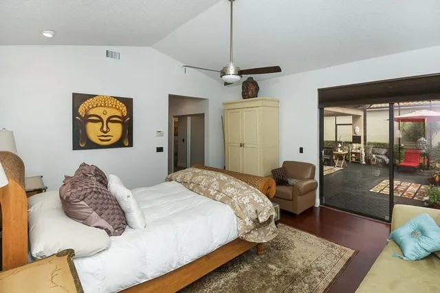 a bedroom with a bed couch and dresser