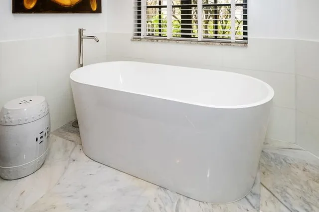 a white bath tub sitting next to a window