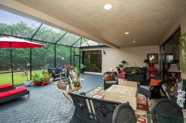 a view of outdoor dining space with furniture and garden view