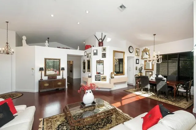 a living room with furniture or couch and a chandelier