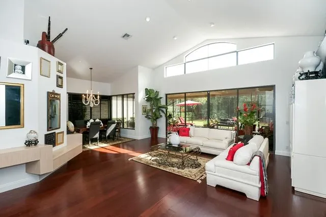 a living room with furniture and large windows